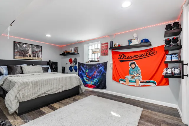 a bedroom with large bed and wall paintings