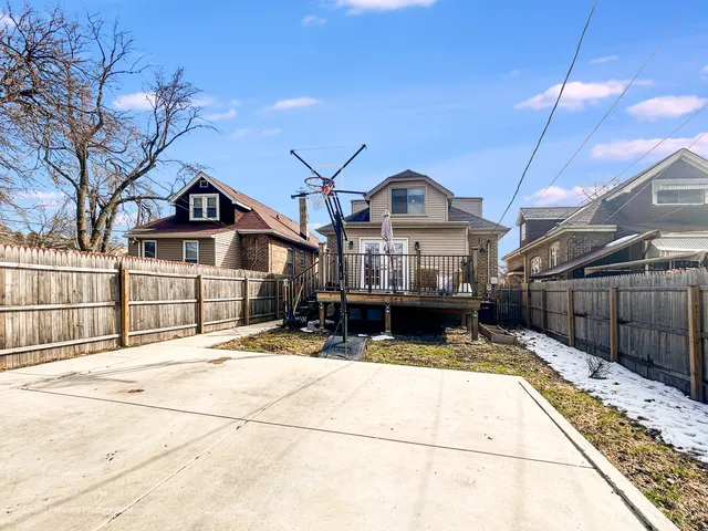 a view of a house with a wooden fence