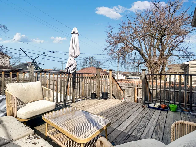 a view of a patio with iron fence