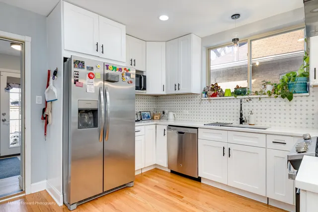 a kitchen with stainless steel appliances granite countertop a refrigerator and a sink