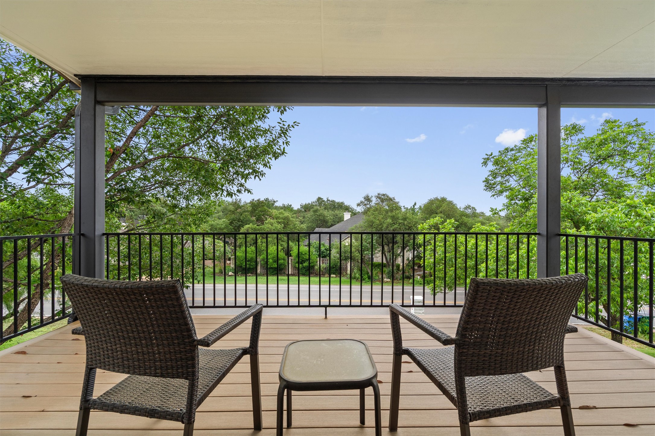 307 Hurst Creek Road Austin, TX 78734 - Photo 26 of 40 Covered outdoor balcony featuring wood-finish flooring, black metal railings, and structural posts