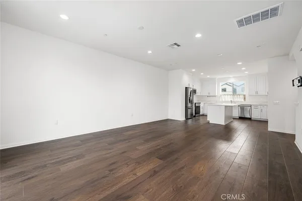 an empty room with a cabinet and mirrors