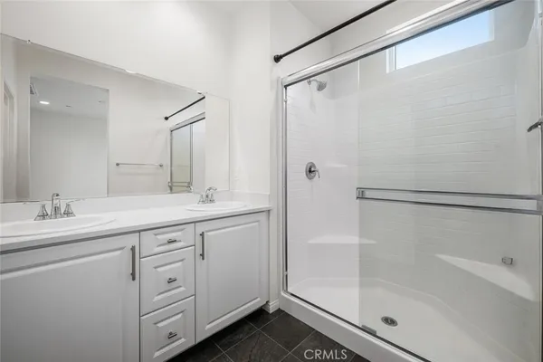 a view of a white house with a yard patio and swimming pool