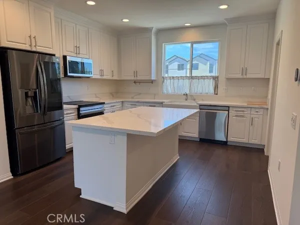 a view of kitchen with stove and wooden floor