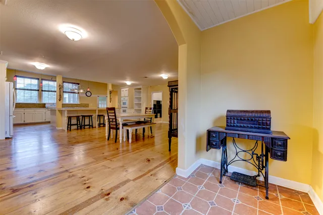 a living room with furniture and a table with wooden floor