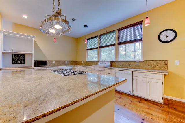a kitchen with stainless steel appliances granite countertop a sink and a granite counter tops