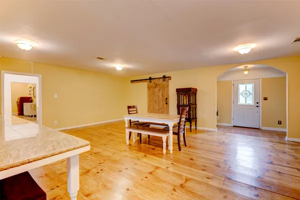 a view of a livingroom with furniture wooden floor and front door