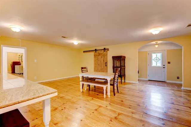 a view of a livingroom with furniture wooden floor and front door