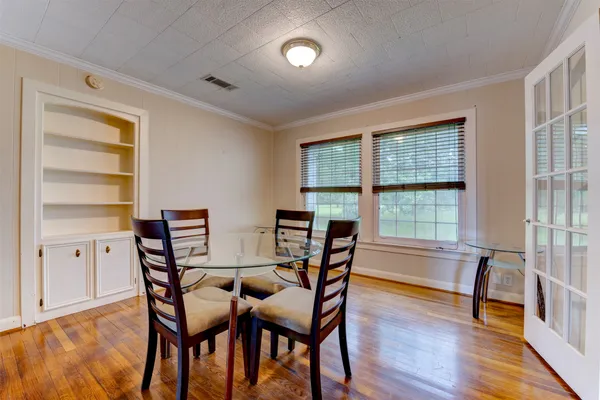a view of a dining room with furniture and a window