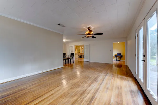 a view of empty room with wooden floor