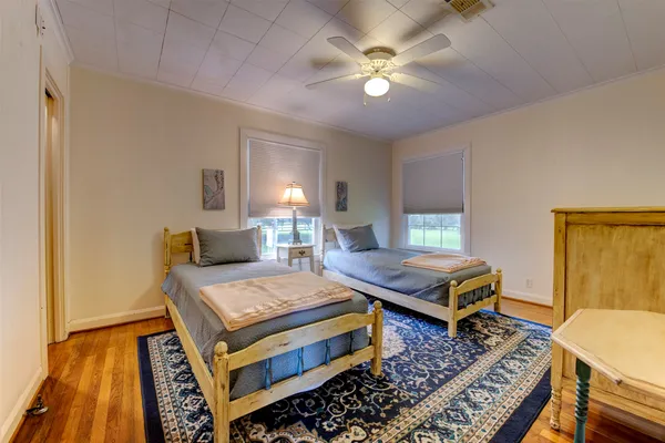 a bedroom with a bed and wooden floor