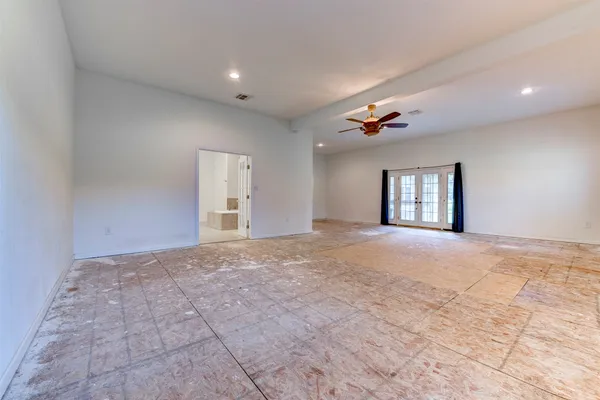 a view of a room with a ceiling fan and window