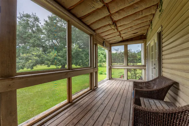 a view of a room with wooden floor and outdoor space