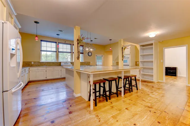 a large kitchen with lots of counter space and windows