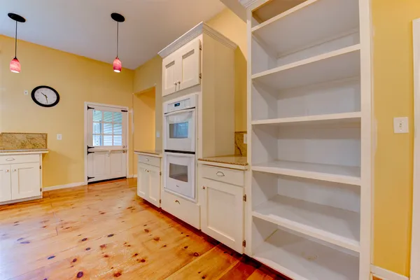 a view of a kitchen with refrigerator and cabinet