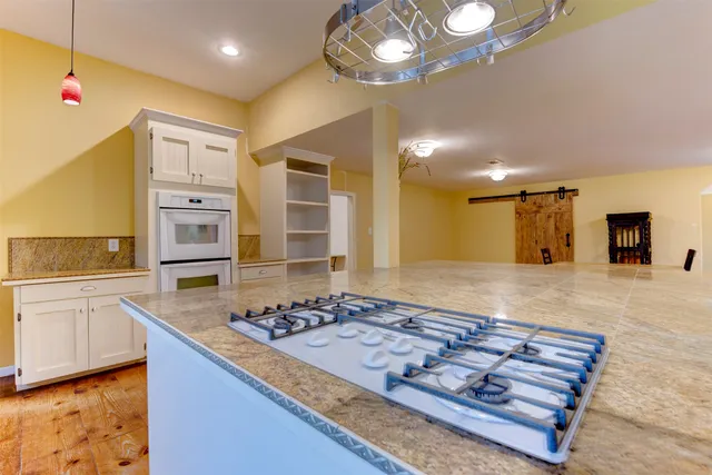a kitchen with stove and cabinets