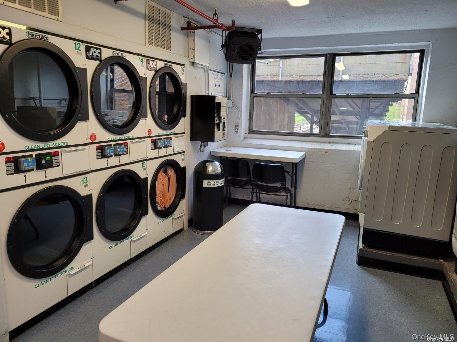 118-17 Union Turnpike, Unit 14E Queens, NY 11375 - Photo 16 of 24 a utility room with dryer and washer