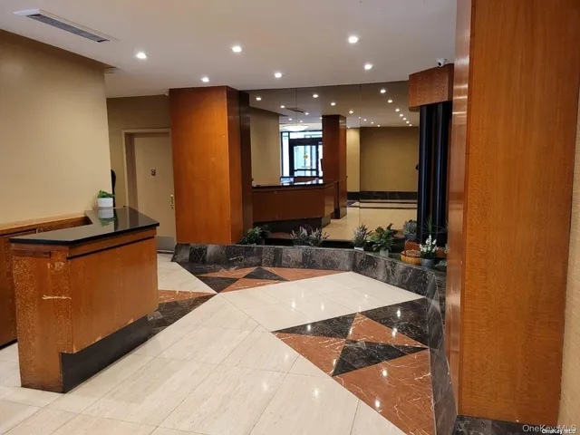 a lobby with a couch and a view of living room