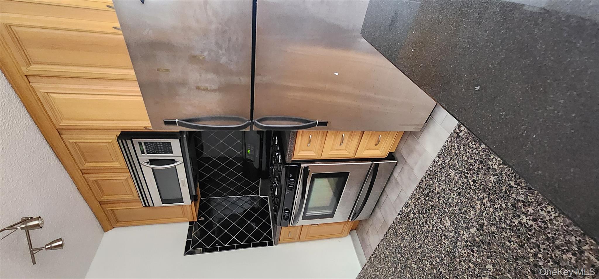 118-17 Union Turnpike, Unit 14E Queens, NY 11375 - Photo 7 of 24 a kitchen with a stove and a microwave