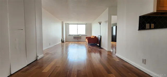 a view of a livingroom with wooden floor and furniture