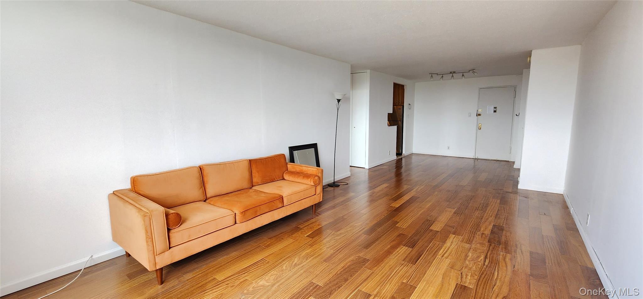 118-17 Union Turnpike, Unit 14E Queens, NY 11375 - Photo 10 of 24 a living room with couch and a wooden floor