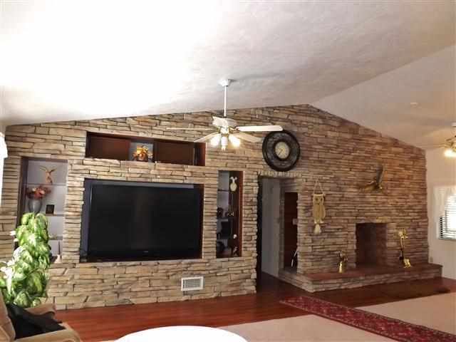 2097 Chevelon Road Overgaard, AZ 85933 - Photo 14 of 35 a fireplace with table and chairs