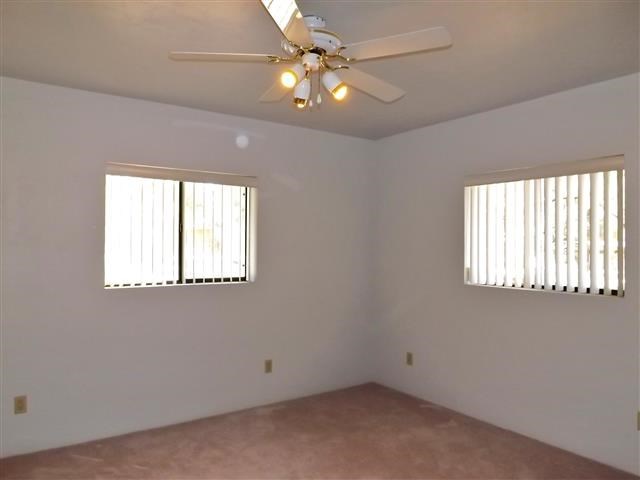 2097 Chevelon Road Overgaard, AZ 85933 - Photo 25 of 35 an empty room with windows and fan
