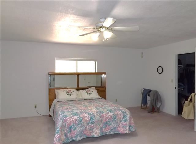 2097 Chevelon Road Overgaard, AZ 85933 - Photo 29 of 35 a bedroom with a bed and a flat tv screen on dresser
