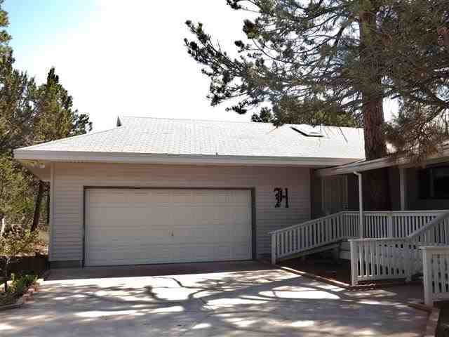 2097 Chevelon Road Overgaard, AZ 85933 - Photo 3 of 35 a front view of a house with a garage