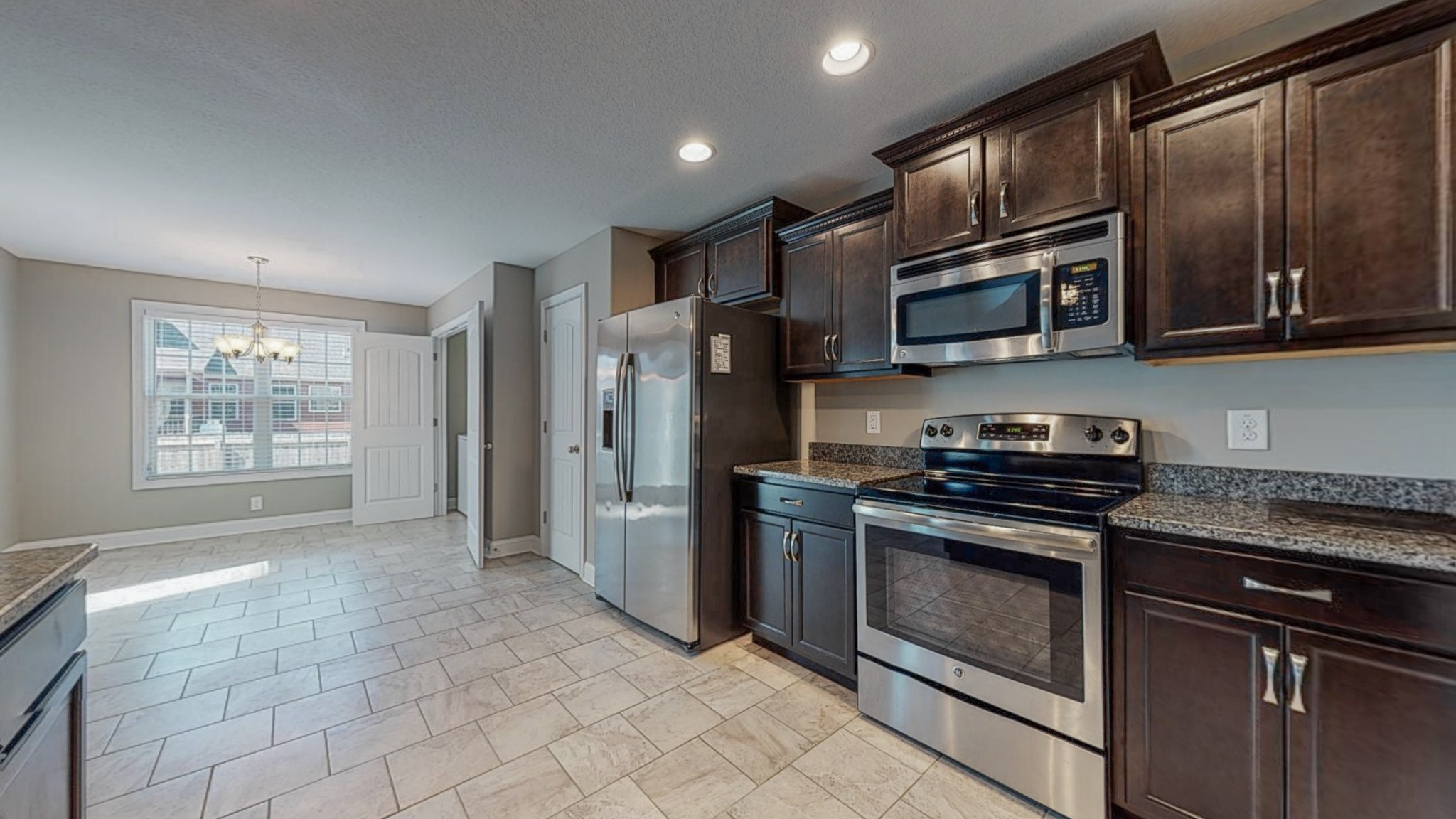 3788 Suiter Road Clarksville, TN 37040 - Photo 13 of 35 a kitchen with stainless steel appliances granite countertop a stove a refrigerator and a microwave