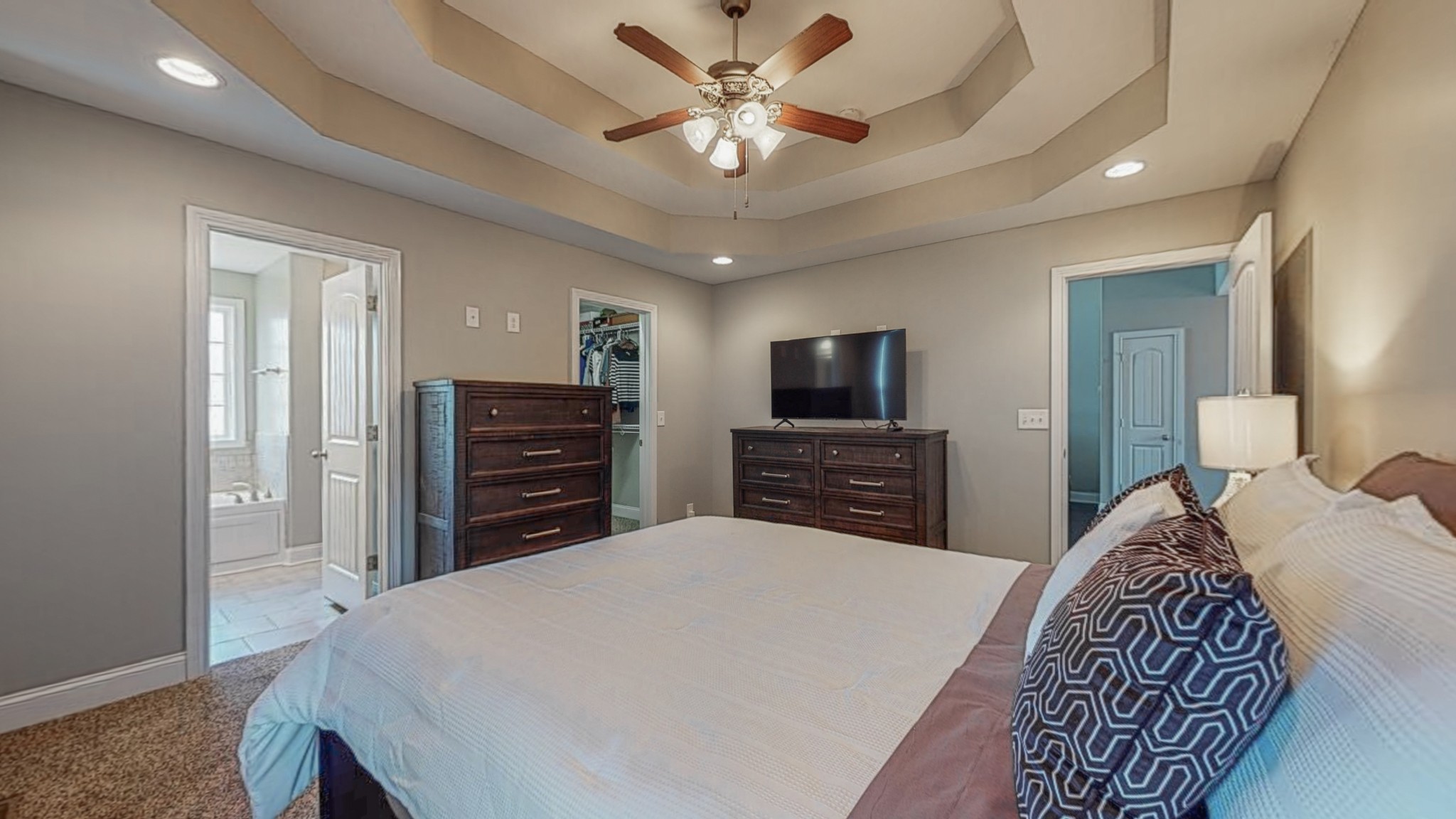3788 Suiter Road Clarksville, TN 37040 - Photo 17 of 35 a spacious bedroom with a bed a dresser and a chandelier