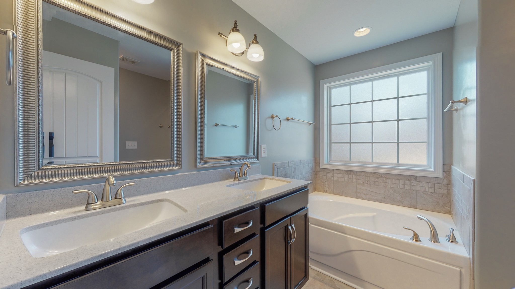 3788 Suiter Road Clarksville, TN 37040 - Photo 19 of 35 a bathroom with a tub double sink and mirror