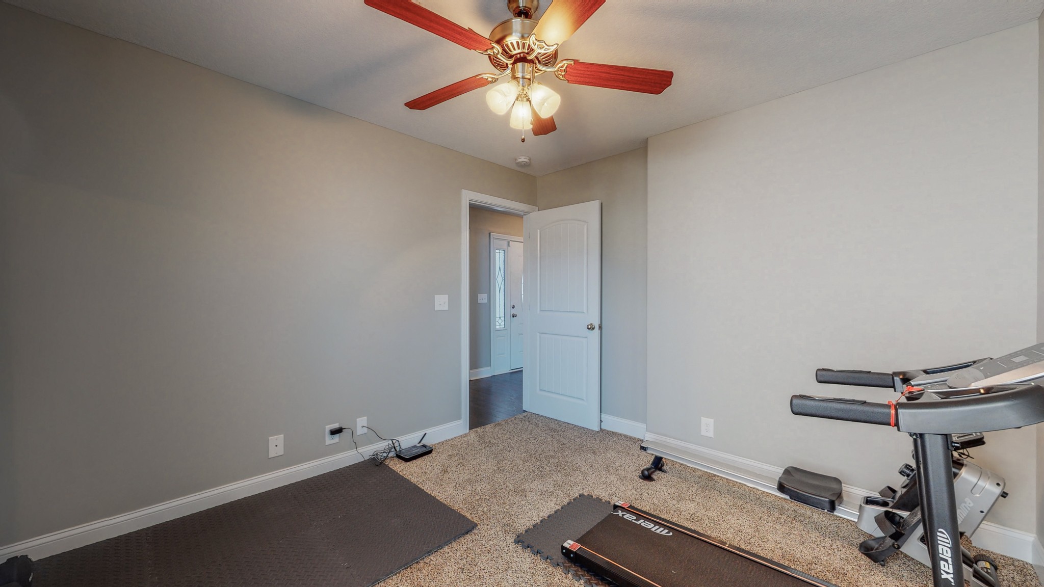 3788 Suiter Road Clarksville, TN 37040 - Photo 24 of 35 a room with gym equipment and a chandelier