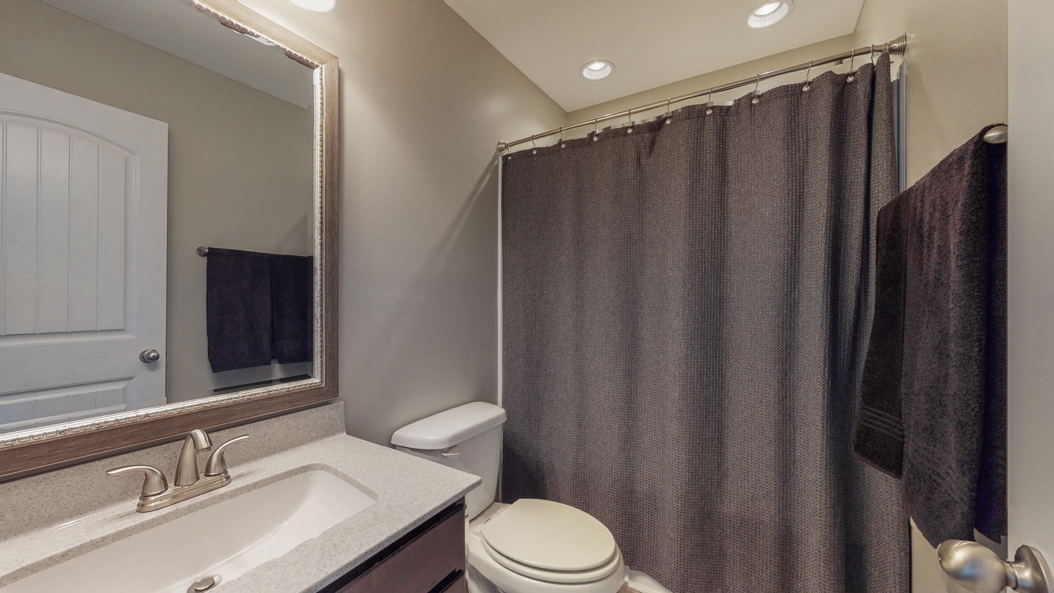 3788 Suiter Road Clarksville, TN 37040 - Photo 26 of 35 a bathroom with a sink a toilet a mirror and shower curtain