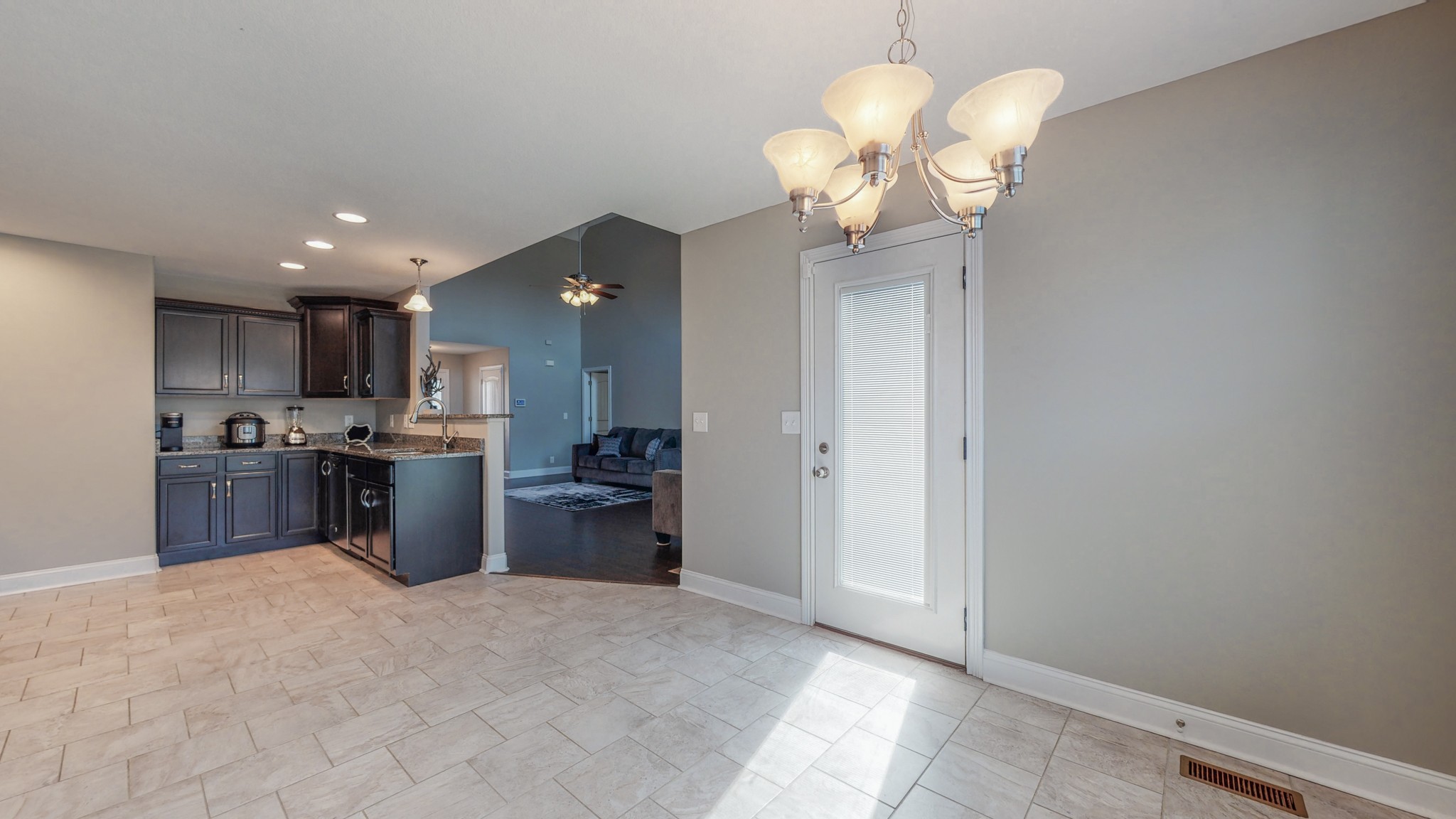 3788 Suiter Road Clarksville, TN 37040 - Photo 10 of 35 a open kitchen with a refrigerator a stove top oven a sink and dishwasher