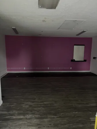 a view of room with wooden floor