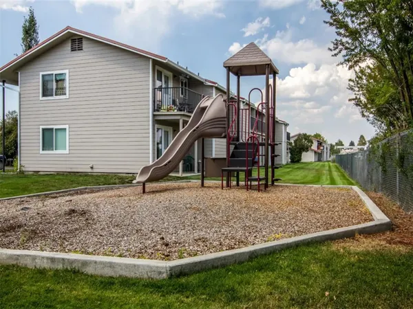 a view of a house with backyard and trees
