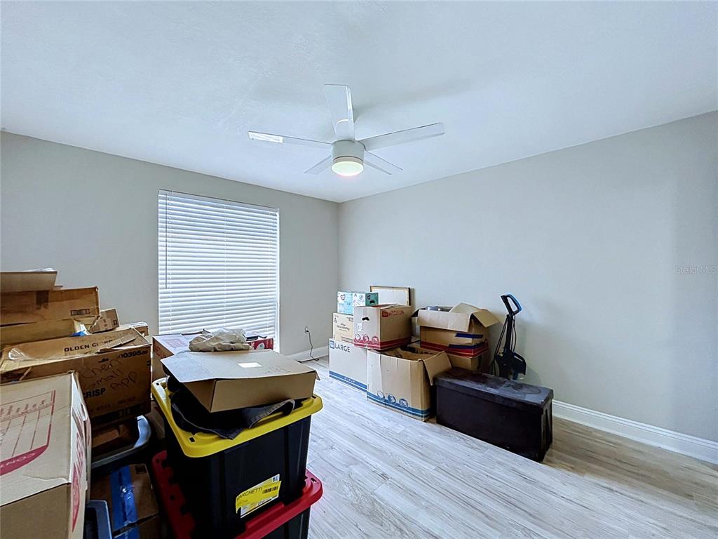4227 Sheldon Place New Port Richey, FL 34652 - Photo 13 of 25 a bedroom with furniture and wooden floor