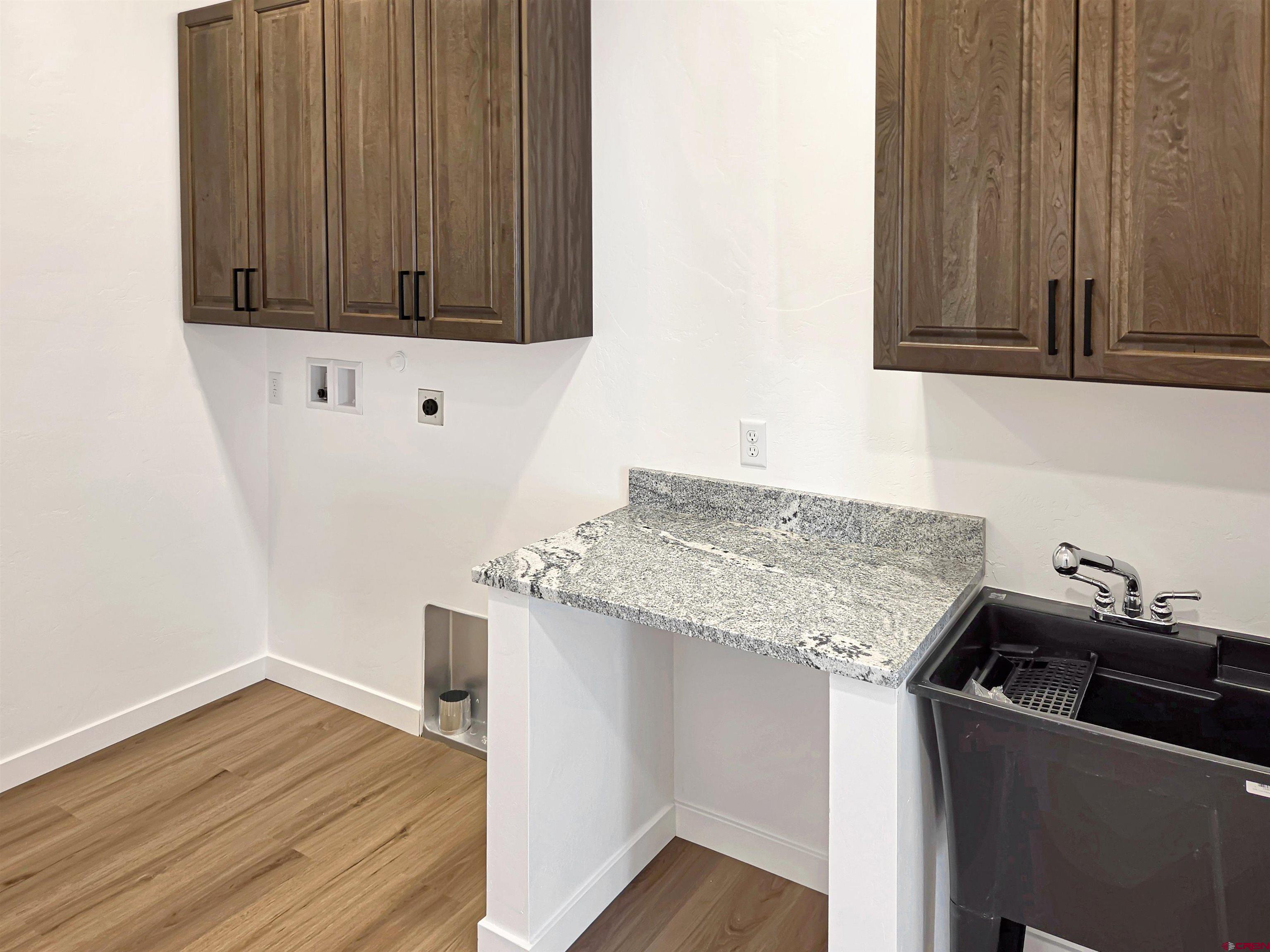 1456 Acoma Street Cortez, CO 81321 - Photo 20 of 26 a kitchen with granite countertop a sink and cabinets