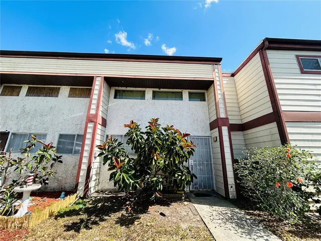 a front view of a house with plants