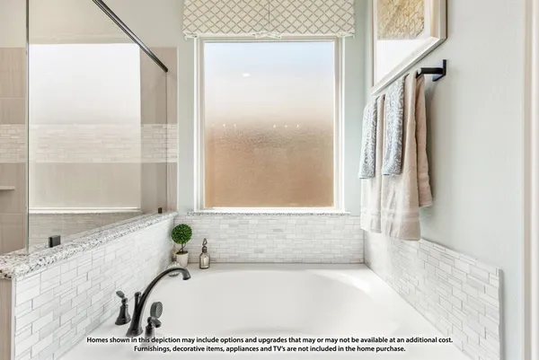 a bathroom with a tub and a shower