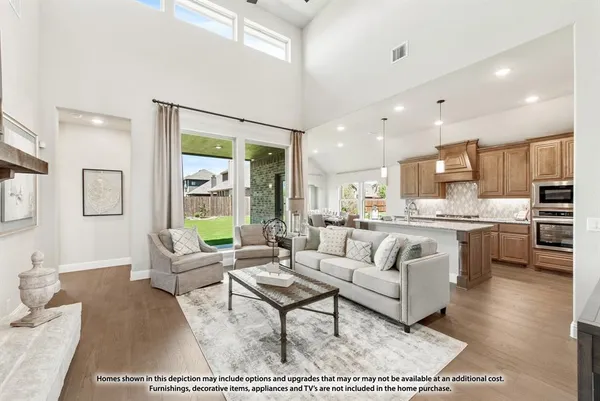 a living room with stainless steel appliances furniture and a rug