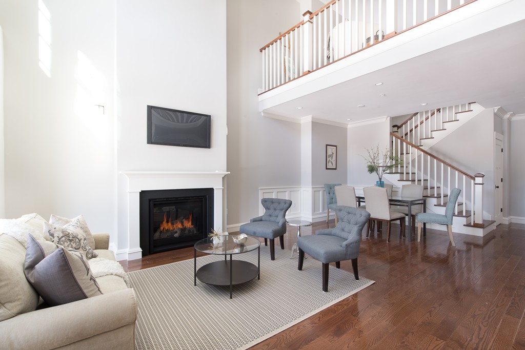 8 Abbey Road, Unit 8 South Walpole, MA 02071 - Photo 2 of 11 a living room with furniture and a fireplace