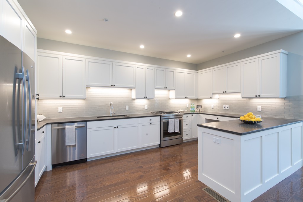 8 Abbey Road, Unit 8 South Walpole, MA 02071 - Photo 3 of 11 a kitchen with granite countertop white cabinets and stainless steel appliances