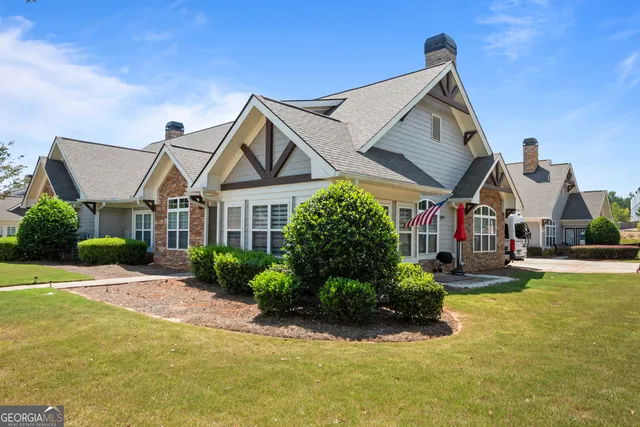 a front view of a house with a yard table and chairs