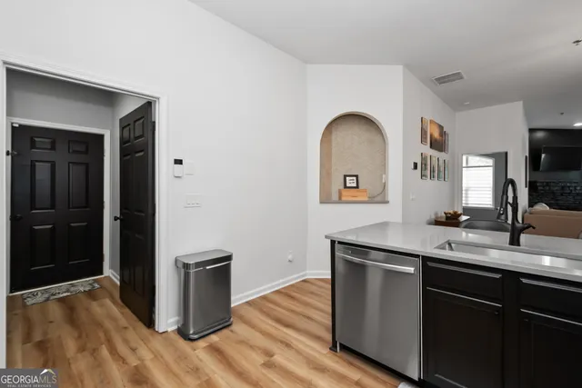 a kitchen with a sink and a refrigerator
