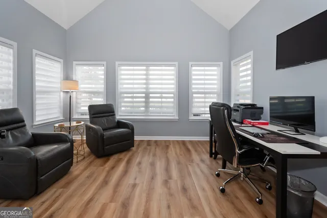 a view of a livingroom with workspace and a window