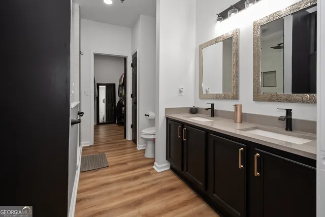 a kitchen with a sink and a wooden floor