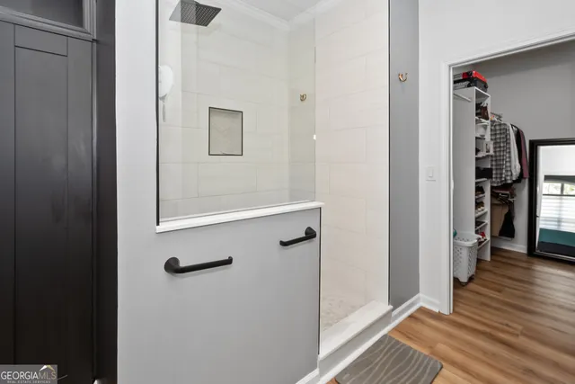 a view of walk in closet with clothes