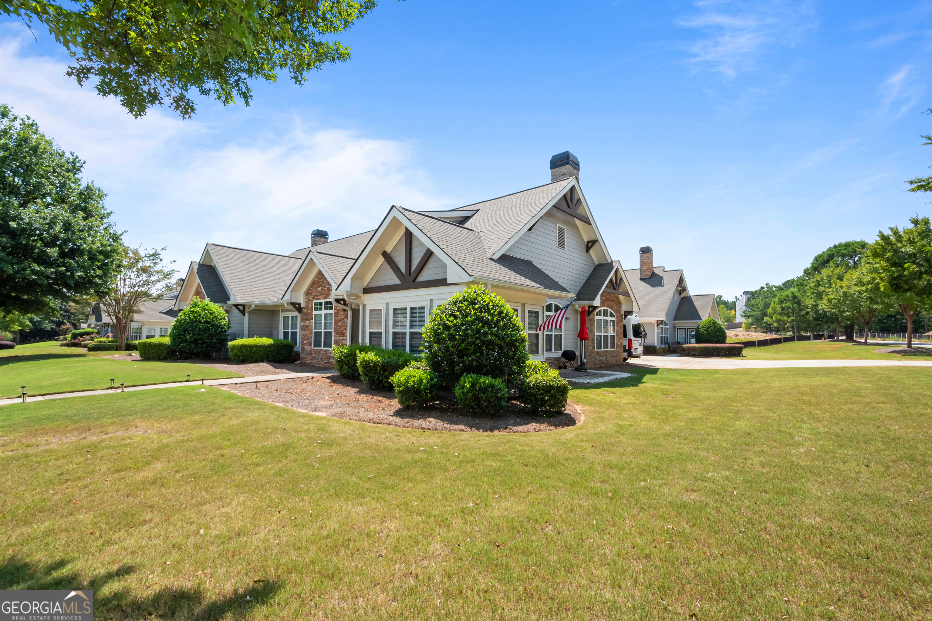 71 Thomaston Street Newnan, GA 30263 - Photo 35 of 38 a view of a house with a big yard and potted plants